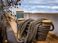 Traditional wooden cleatÃÂ and coiled ropes on US tallship Eagle